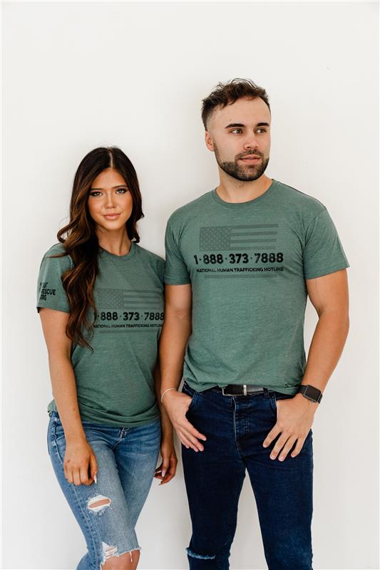 Two people wearing matching green t-shirts with a phone number design on a white background
