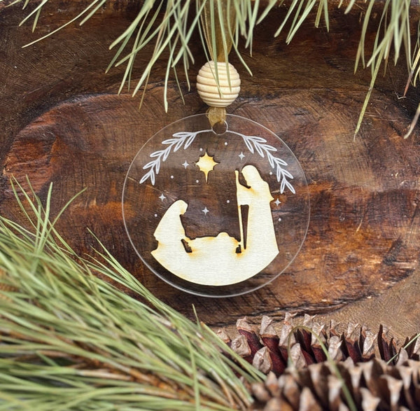 Decorative Christmas ornament with nativity scene on a wooden background
